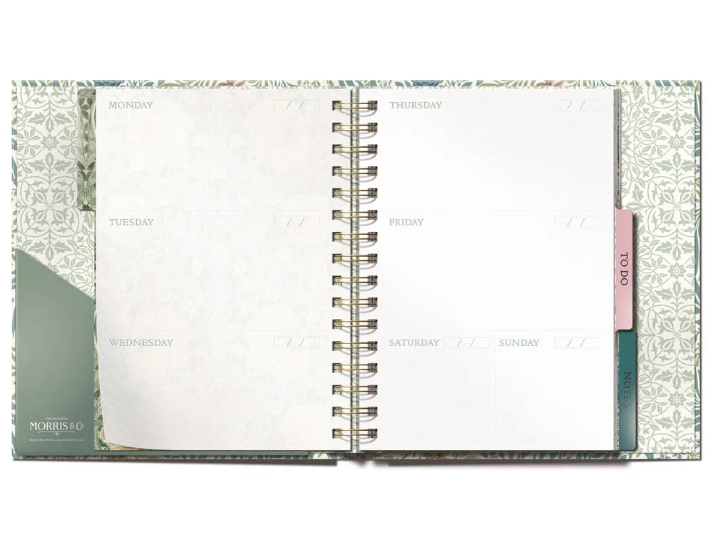Elegant botanical weekly planner open on desk